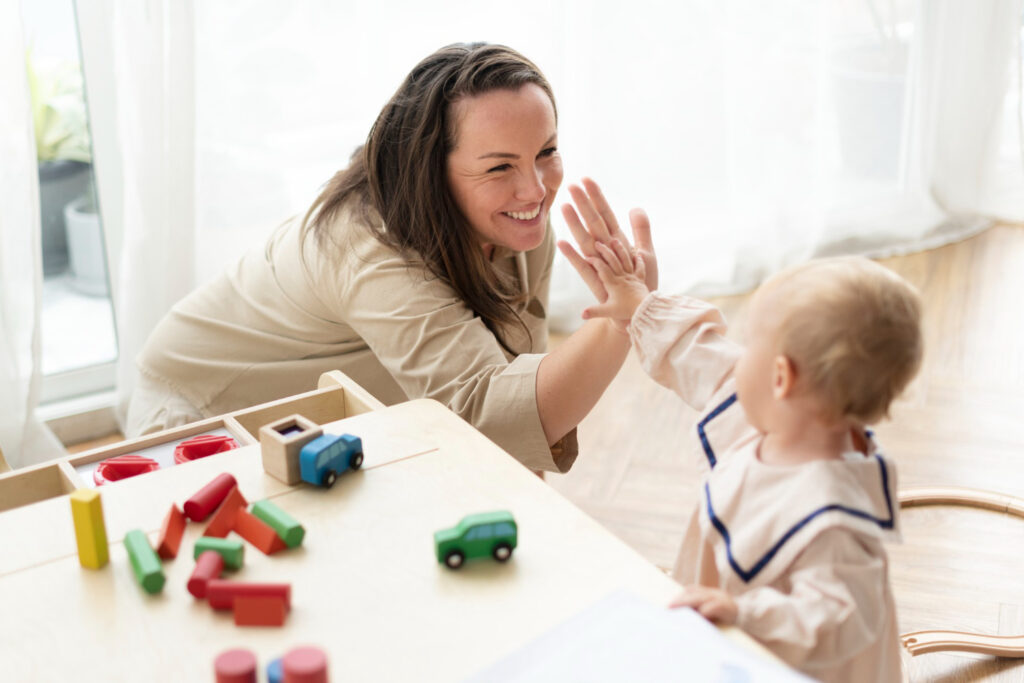 Woman and baby giving high fives